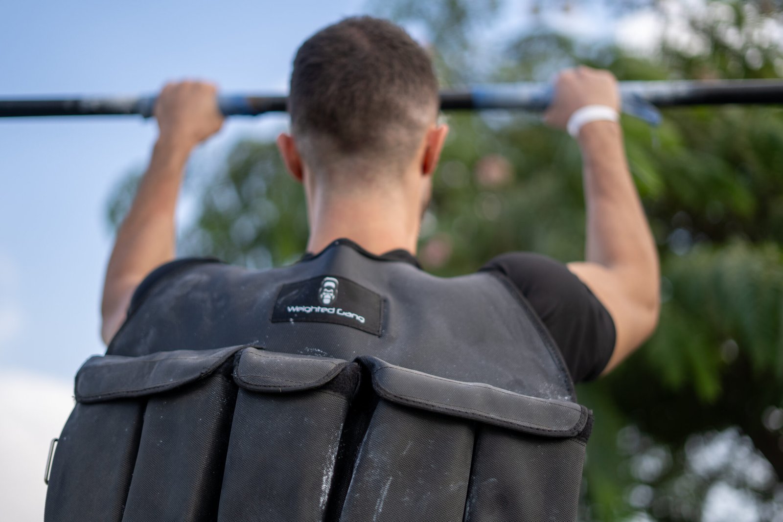 Man wearing a 10KG weighted vest during outdoor workout.