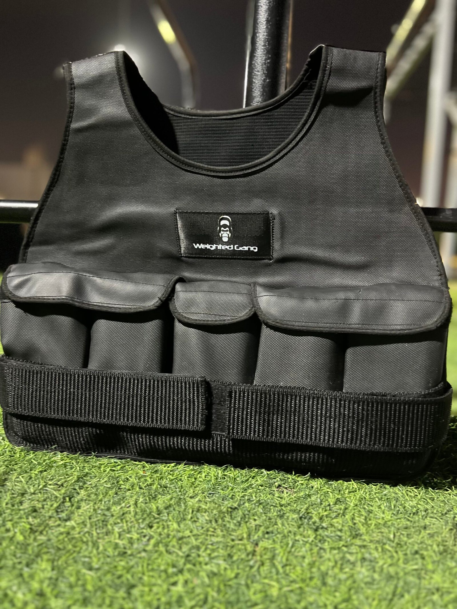 Black weighted vest with multiple pouches for weight training and fitness.