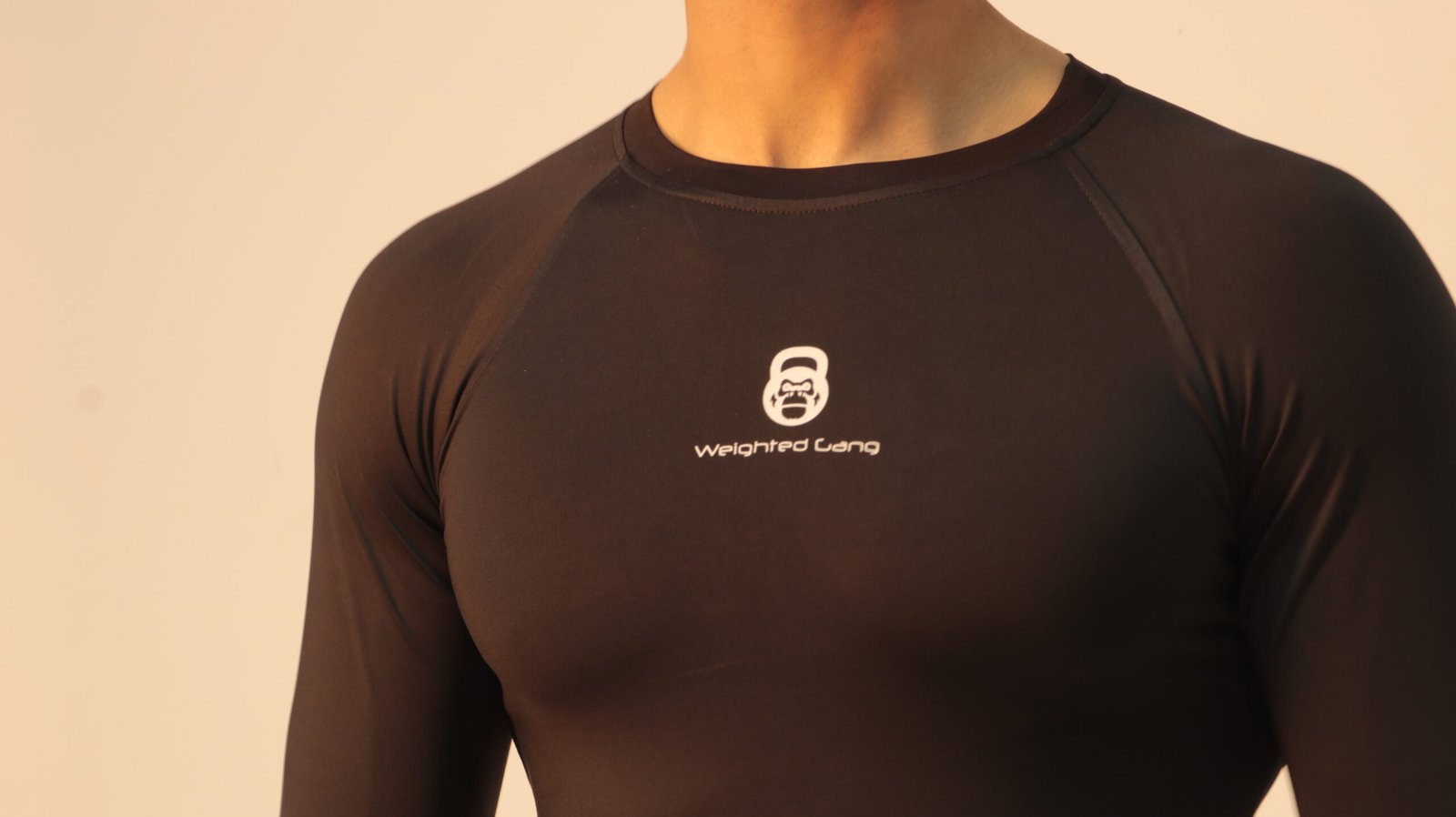 Close-up of a man wearing a black WG Compression Long Sleeve shirt.